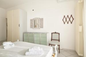 a bedroom with a bed with a chair and a mirror at SottoVento in Imperia +48 photos