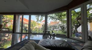 a living room with a pool and large windows at Gästehaus Weinwurm in Obritz