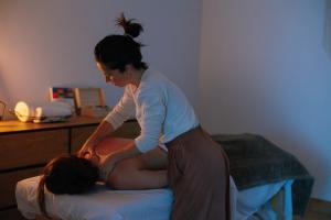 a woman is helping a woman on a bed at Amari in Getaria