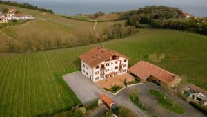 an aerial view of a large house in a field at Amari in Getaria