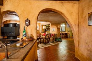 a kitchen and living room with an archway in a house at Villa La Fortezza in Dormelletto