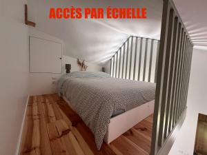a bedroom with a bed in a white room at La petite maison de Boisrival in Bury