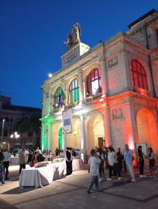 a group of people standing in front of a building at B&B Antonello da Messina in Messina