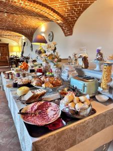 a buffet with many different types of food on a table at Cascina Baronina in Terruggia