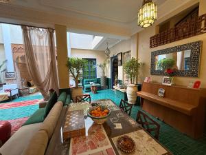 a living room with a couch and a table at Riad Atrium & Spa in Marrakesh