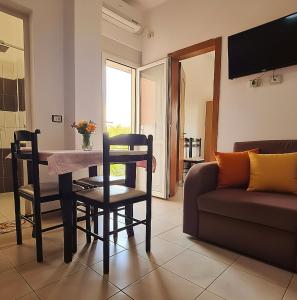 a living room with a table and a couch at Hotel Gonaj in Velipojë