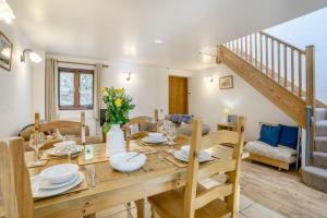 a dining room and living room with a wooden table at 2 Bed in Risca oc-b35977 in Risca +13 photos