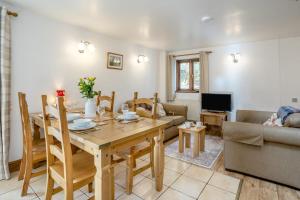 a living room with a wooden table and a couch at 2 Bed in Risca oc-b35977 in Risca