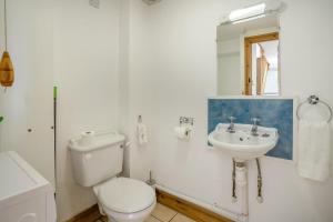 a white bathroom with a toilet and a sink at 2 Bed in Risca oc-h35978 in Risca +17 photos