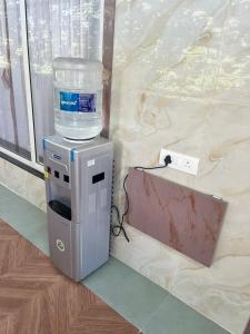 a water cooler with a bucket on top of it at Bachelor Stay - CBD Belapur in Navi Mumbai