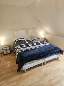 a bedroom with a large bed in a attic at gîte Brocéliande - Harmonie et tranquillité près de la mer in Theix +25 photos