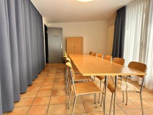 a conference room with a long table and chairs at Abenteuer Turm in Braunwald