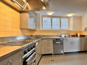 a kitchen with a sink and a stove top oven at Abenteuer Turm in Braunwald