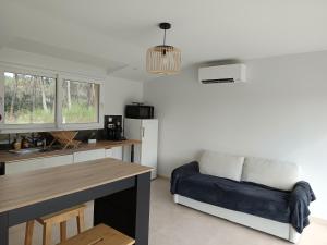 a living room with a couch and a table at Appartement Marilou in Pompiey
