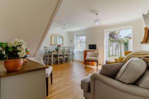 a living room with a couch and a dining room at 3 Bed in Reydon oc-a36049 in Reydon