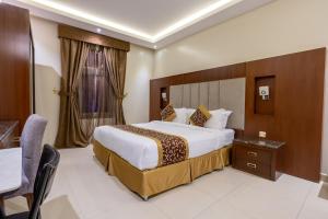 a hotel room with a large bed and a desk at Al Muhaidb Residence Al Malaz 1 - Economic in Riyadh