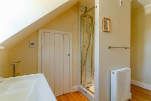 a bathroom with a white sink and a staircase at 3 Bed in Reydon oc-a36049 in Reydon +19 photos