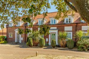a red brick building with plants in front of it at 3 Bed in Reydon oc-a36049 in Reydon