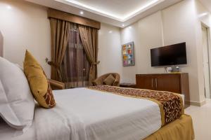 a hotel room with a bed and a television at Al Muhaidb Residence Al Malaz 1 - Economic in Riyadh