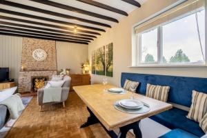 a living room with a blue couch and a table at 2 Bed in Beaconsfield oc-t35951 in Beaconsfield