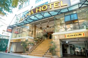 a hotel with stairs in front of a building at khách sạn Aloha in Hanoi