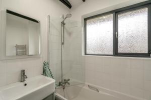 a white bathroom with a sink and a window at 2 Bed in Beaconsfield oc-t35951 in Beaconsfield +13 photos