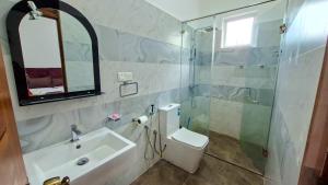 a bathroom with a toilet and a sink and a shower at Haven Stay in Sri Jayewardenepura Kotte +53 photos