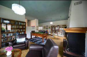 a living room with a pool table and a library at Casa Hydrangea con piscina e giardino in Bagni di Lucca