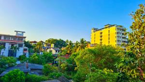a yellow building in the middle of a city at Haven Stay in Sri Jayewardenepura Kotte