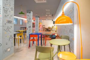 a dining room with colorful tables and chairs at Ostello Bello Milano Duomo in Milan