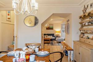 a dining room and living room with a table and chairs at 3 Bed in Appledore oc-t28375 in Appledore