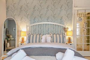 a bedroom with a large bed with blue and white stripes at 3 Bed in Appledore oc-t28375 in Appledore