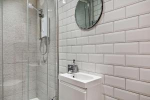 a white bathroom with a sink and a mirror at 3 Bed in Appledore oc-t28375 in Appledore +17 photos