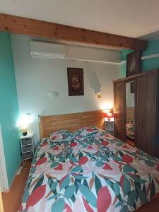 a bedroom with a bed with a colorful bedspread at Maison blanche in Calvisson +14 photos