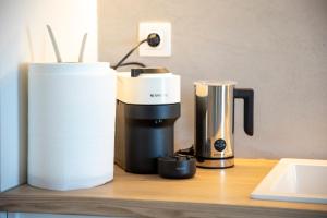 a coffeemaker and a coffee maker on a counter at Infinite Blue Suites in Agia Marina Aegina