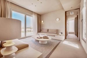 a living room with a couch and a table at Ovea Paros in Naousa
