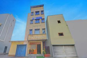 a tall building with a sky guard sign on it at FabHotel SV Grand in Hyderabad