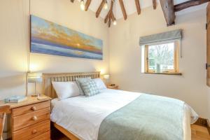 a bedroom with a bed and a painting on the wall at 3 Bed in Tenterden oc-p36303 in Tenterden
