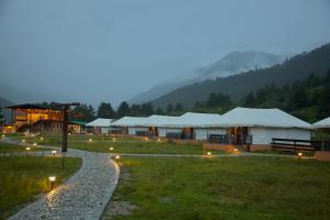 a group of tents in a field with lights at Haa Valley Camp in Kechungka