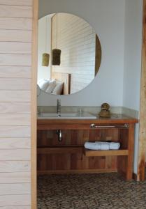 a bathroom with a sink and a mirror at Hotel Simple Patagonia in Puerto Natales