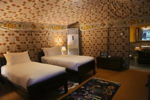 a bedroom with two beds in a room at Haa Valley Camp in Kechungka