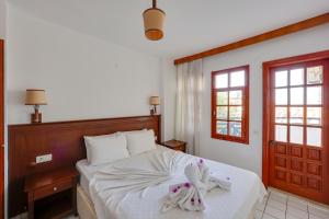 a bedroom with a bed with two towels on it at NATURELLA APART HOTEL in Kemer +63 photos