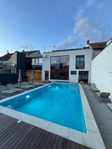 a swimming pool in the backyard of a house at 5 Crowns - Osijek - Free EV - Self check in - Pool in Osijek
