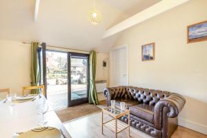 a living room with a leather couch and a table at 2 Bed in Hastingleigh oc-c36343 in Hastingleigh