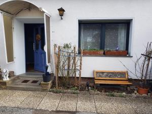 a house with a blue door and a bench at Ferienwohnung Martino in Simmern