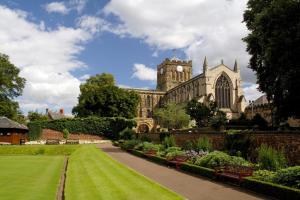 a building with a clock tower and a garden at 1 Bed in Hexham oc-g37537 in Hexham