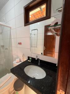 a bathroom with a sink and a toilet at Portal do Sol Lençóis Pousada in Barreirinhas +32 photos