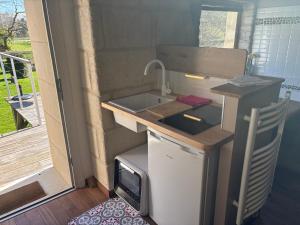 a tiny kitchen with a sink in a tiny house at Mini duplex la Révière in Saintines
