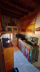 a kitchen with a sink and a counter top at Maison d'hôtes tilleli in Tamnougalt
