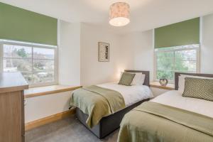 two beds in a room with two windows at 3 Bed in Dunning oc-t35973 in Dunning